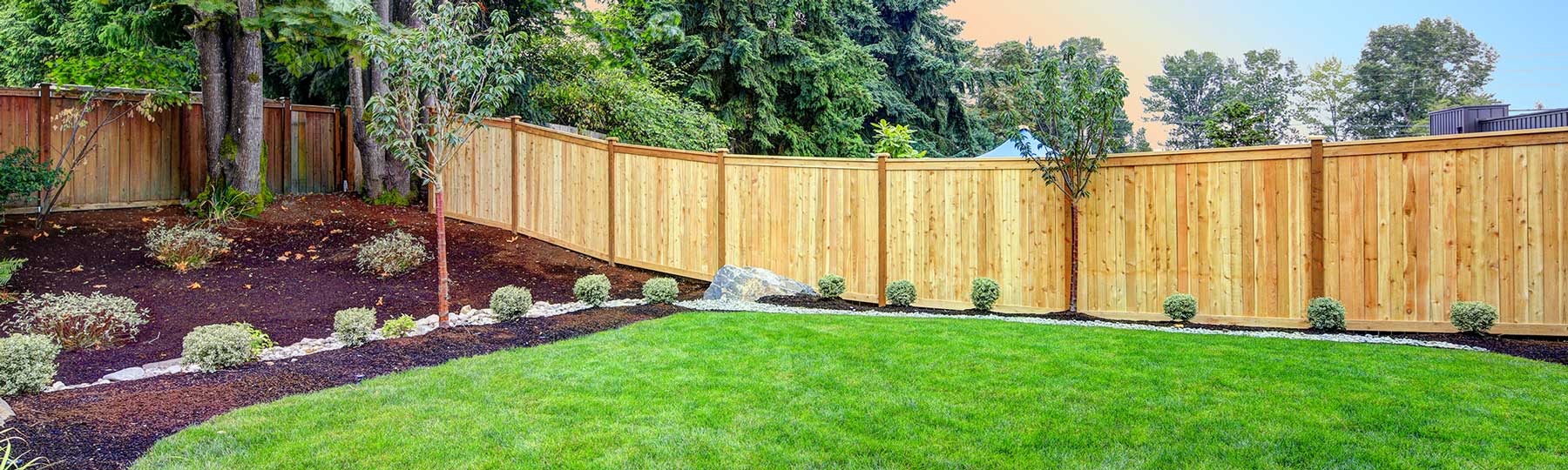 Wooden fence mowed lawn